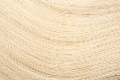 Photo of Texture of healthy blond hair as background, closeup