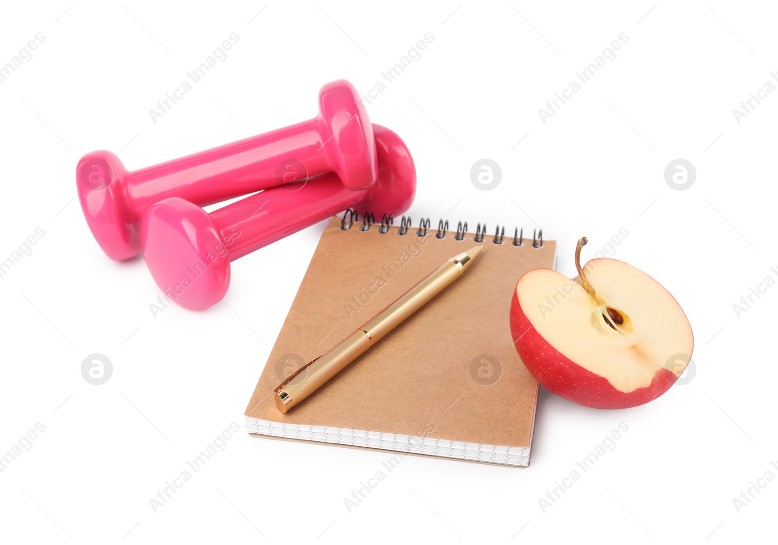 Photo of Healthy diet. Notebook, pen, cut apple and dumbbells isolated on white