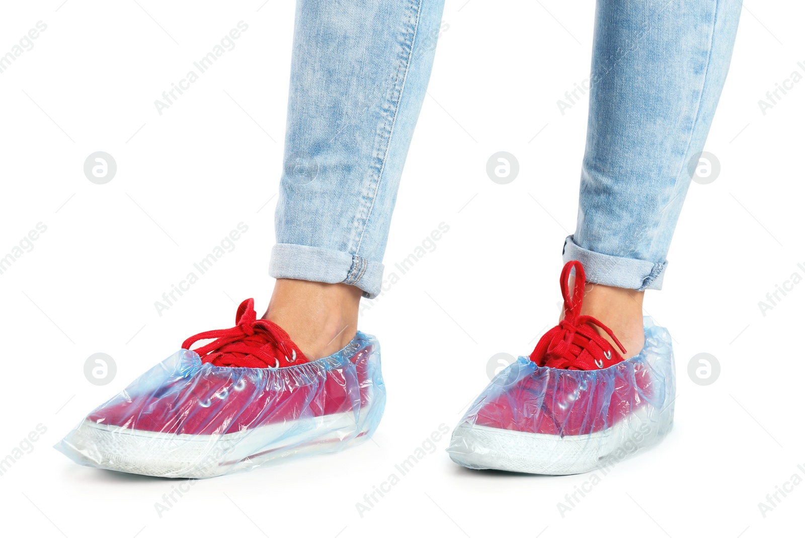 Photo of Woman with blue shoe covers worn over sneakers on white background, closeup