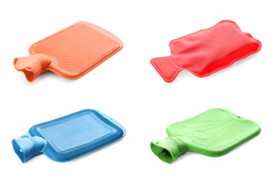 Set with different rubber hot water bottles on white background