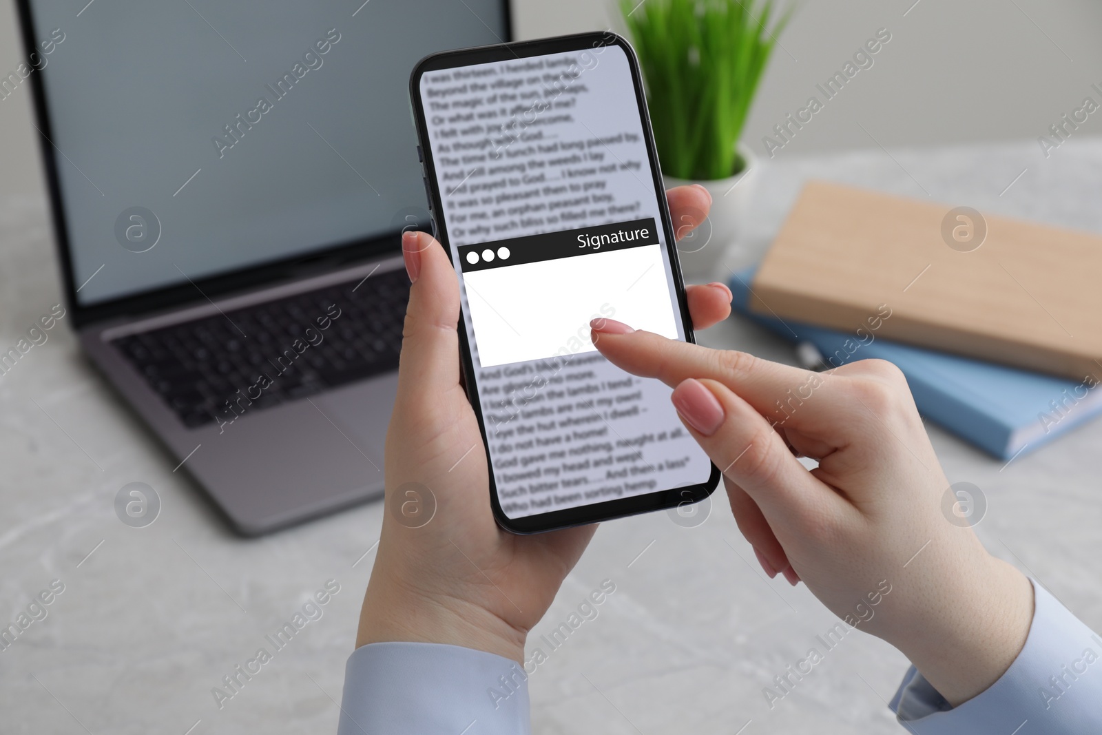 Image of Electronic signature. Woman using mobile phone at table, closeup