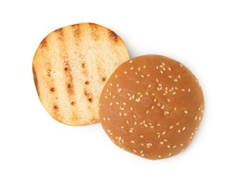 Photo of Halves of grilled burger bun isolated on white, top view