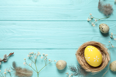 Photo of Flat lay composition with Easter eggs on light blue wooden background. Space for text