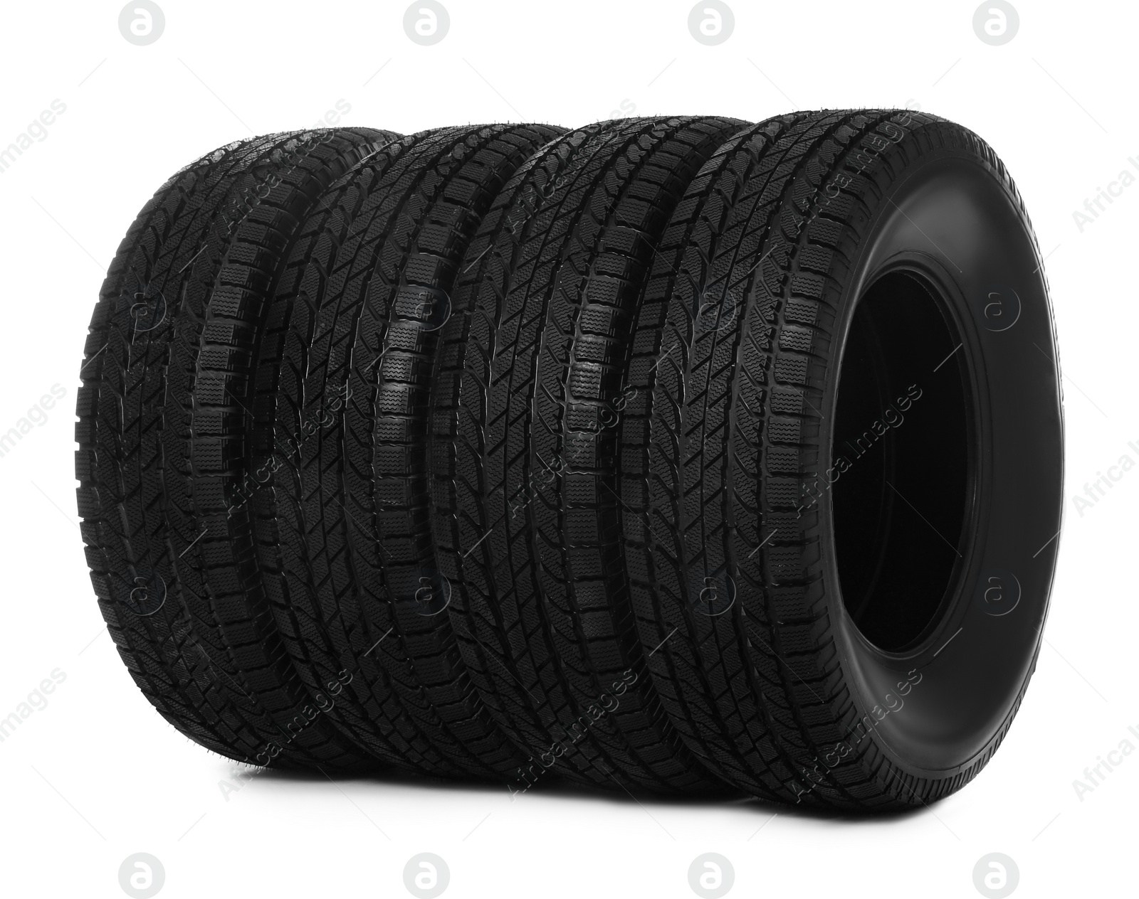 Photo of Set of new winter tires on white background