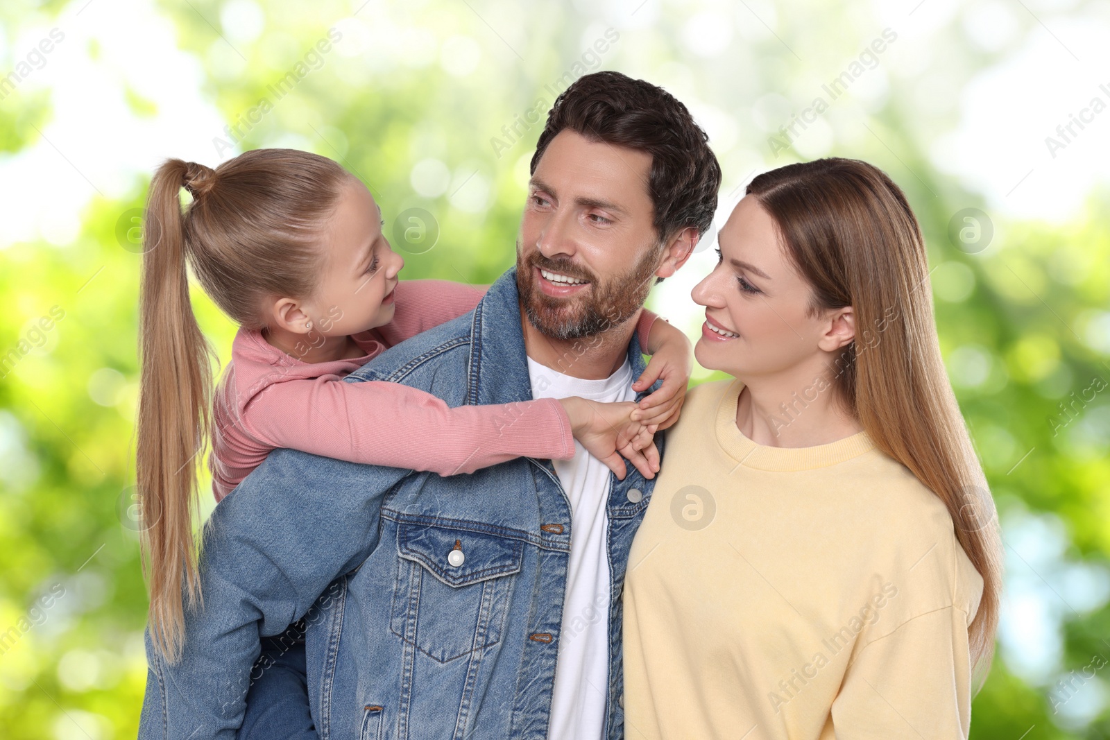 Image of Portrait of happy family with child against blurred background