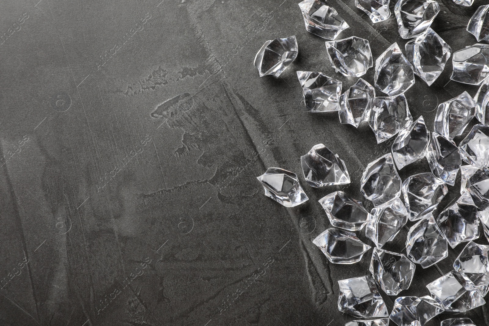 Photo of Pile of crushed ice on grey table, top view. Space for text