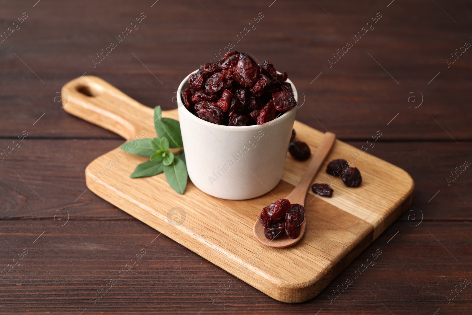 Photo of Composition with tasty dried cranberries on wooden table