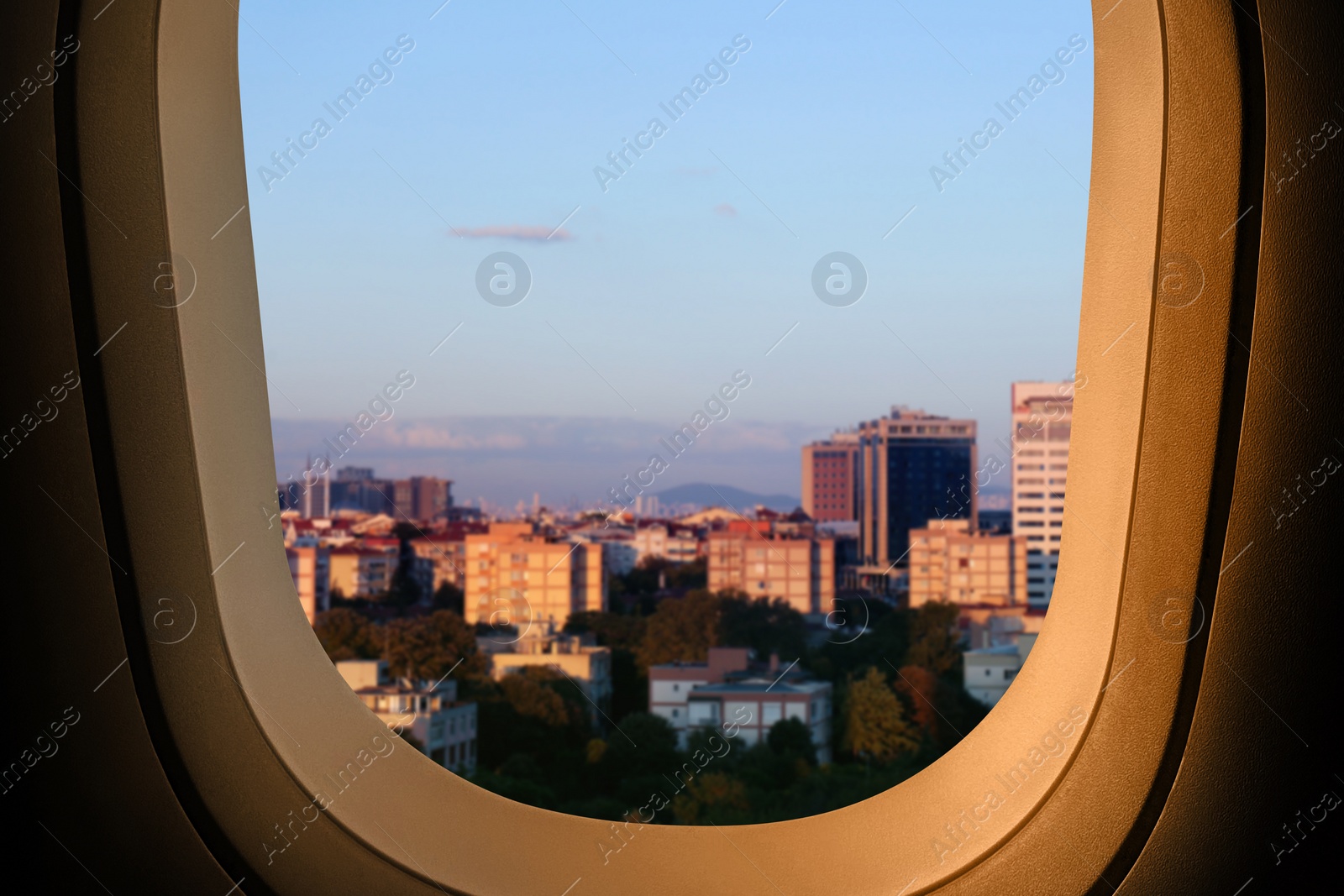 Image of Beautiful city with buildings, view through airplane window during flight