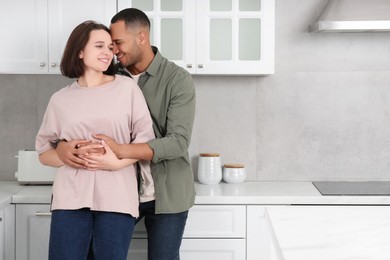 Photo of Dating agency. Lovely couple embracing in kitchen, space for text