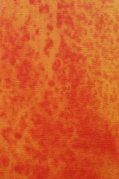 Photo of Orange fabric with pattern as background, top view