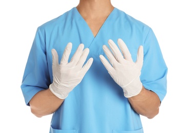 Photo of Male doctor in uniform wearing gloves on white background, closeup. Medical object