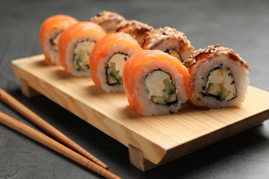 Delicious sushi rolls served on grey table