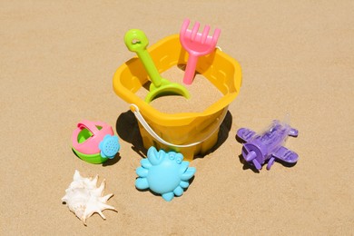 Photo of Set of plastic beach toys on sand