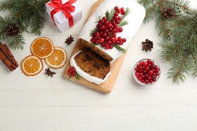 Photo of Traditional Christmas cake and ingredients on white wooden table, flat lay. Classic recipe
