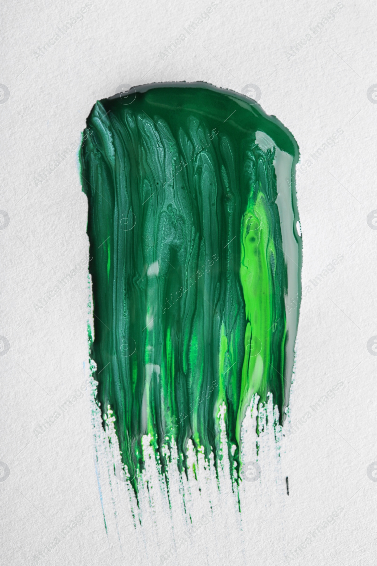 Photo of Abstract brushstroke of green paint isolated on white