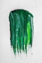 Abstract brushstroke of green paint isolated on white