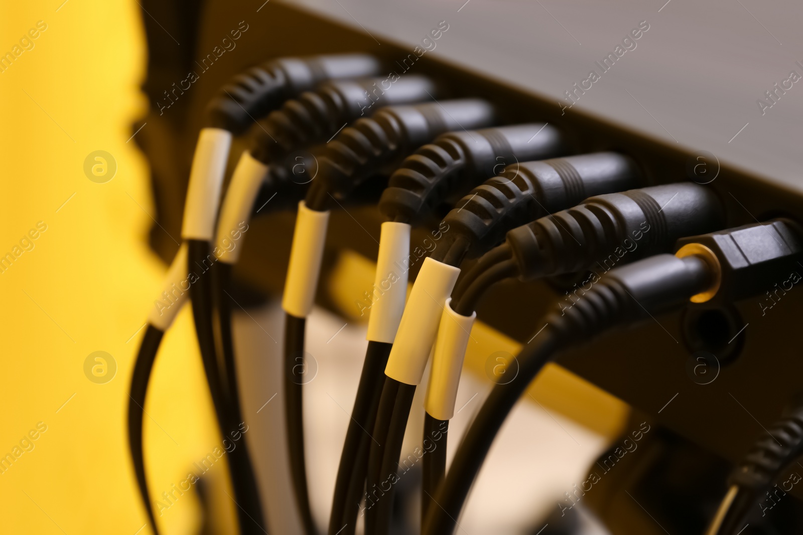 Photo of Modern electronic drum module with cables, closeup. Musical instrument