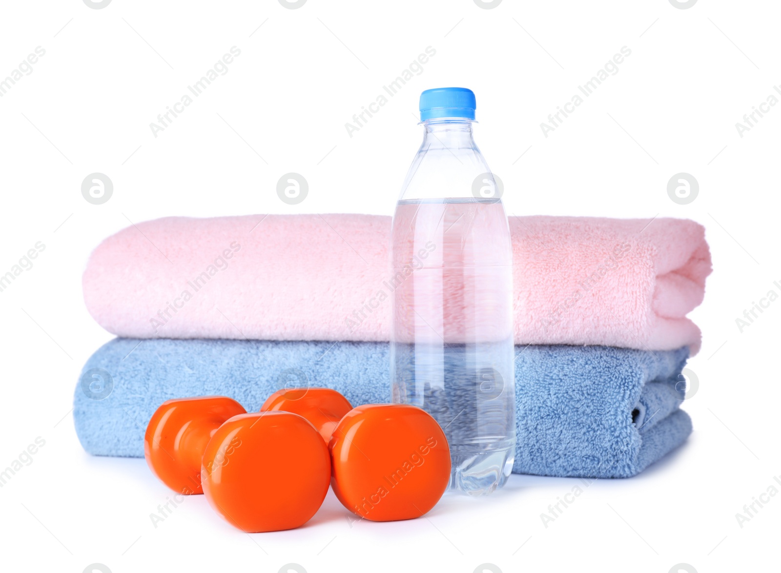 Photo of Stylish dumbbells, bottle of water and towels on white background. Home fitness