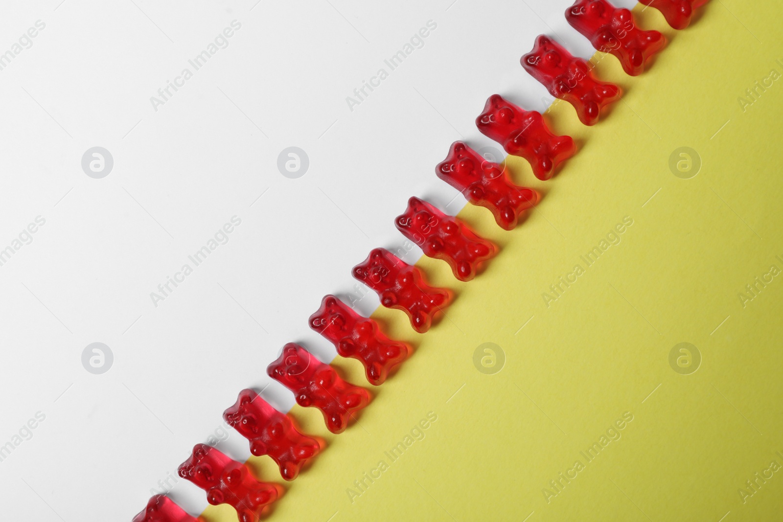 Photo of Delicious jelly bears on color background, top view