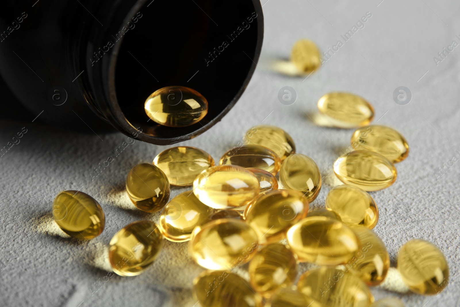 Photo of Bottle with cod liver oil pills on table, closeup