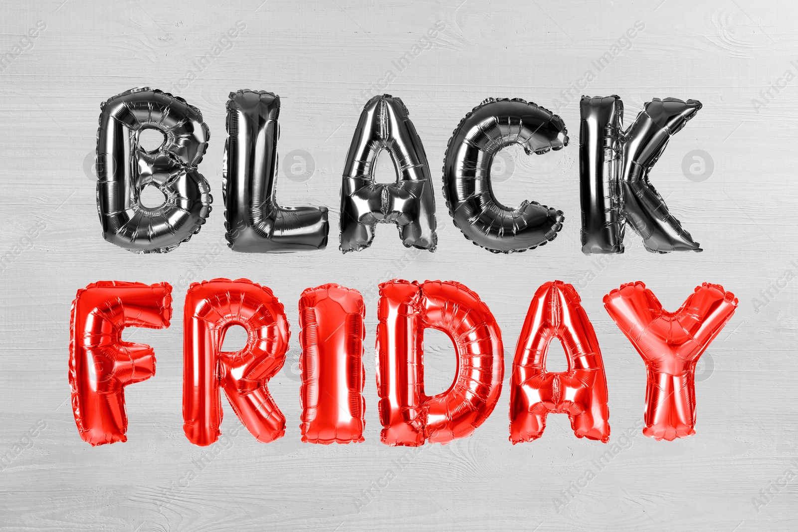 Image of Phrase BLACK FRIDAY made of foil balloon letters on white wooden background