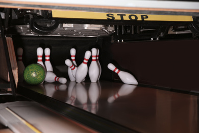 Photo of Ball hitting pins on alley in bowling club