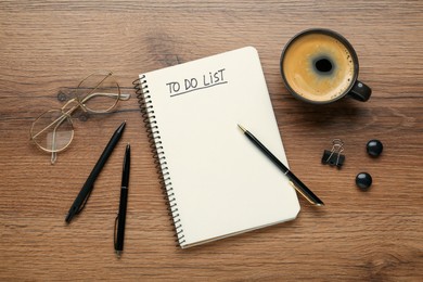 Flat lay composition with unfilled To Do list in notebook and cup of coffee on wooden table