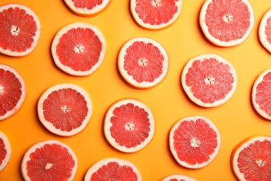 Photo of Fresh sliced ripe grapefruit on color background, flat lay