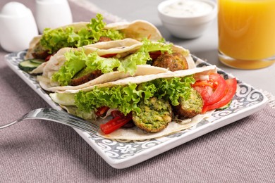 Photo of Delicious fresh vegan tacos served on table