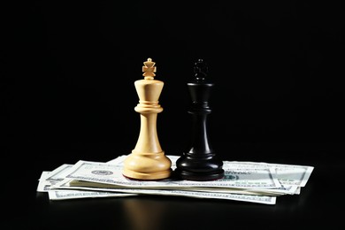 Photo of Money, white and black kings against dark background. Business competition concept