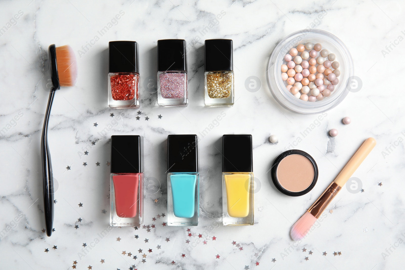 Photo of Flat lay composition with bottles of nail polish and different cosmetics on marble background