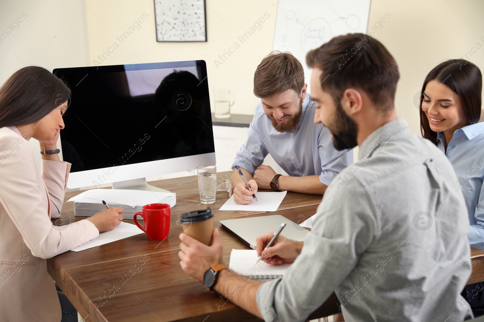 Photo of Group of colleagues using video chat on computer in office. Space for text