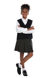 Happy African-American girl in school uniform on white background