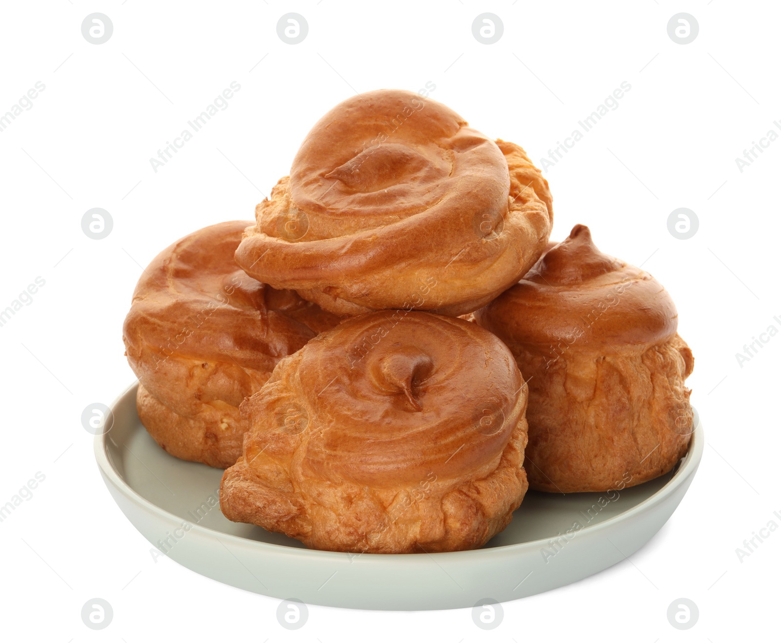 Photo of Pile of delicious profiteroles on white background