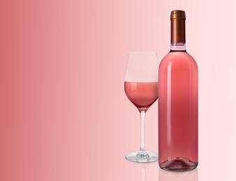 Image of Bottle and glass of delicious rose wine on pink background. Space for text