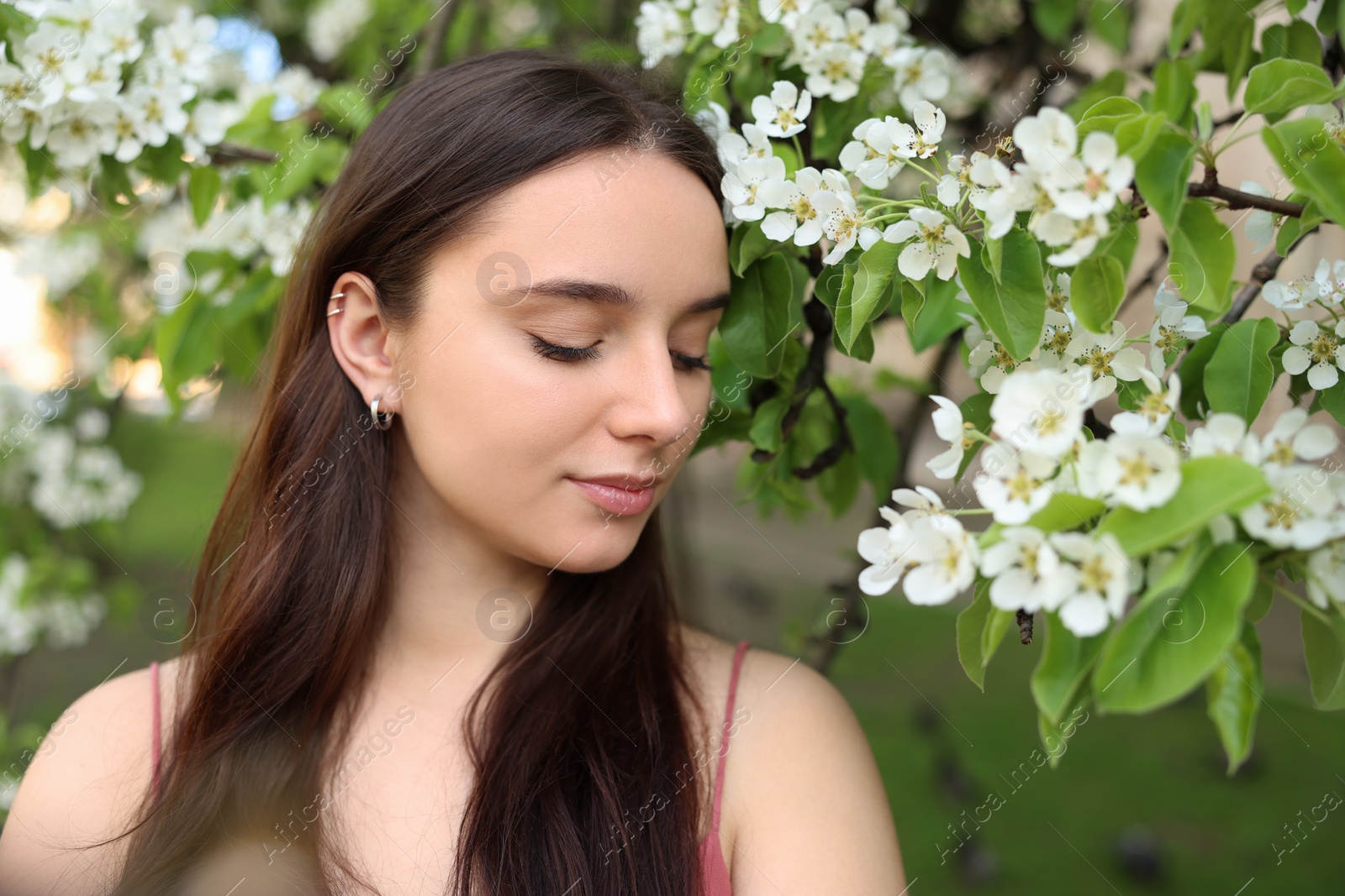 Photo of Beautiful woman near blossoming tree on spring day