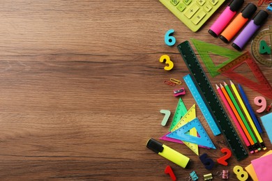 Photo of Flat lay composition with many colorful numbers and stationery on wooden table. Space for text
