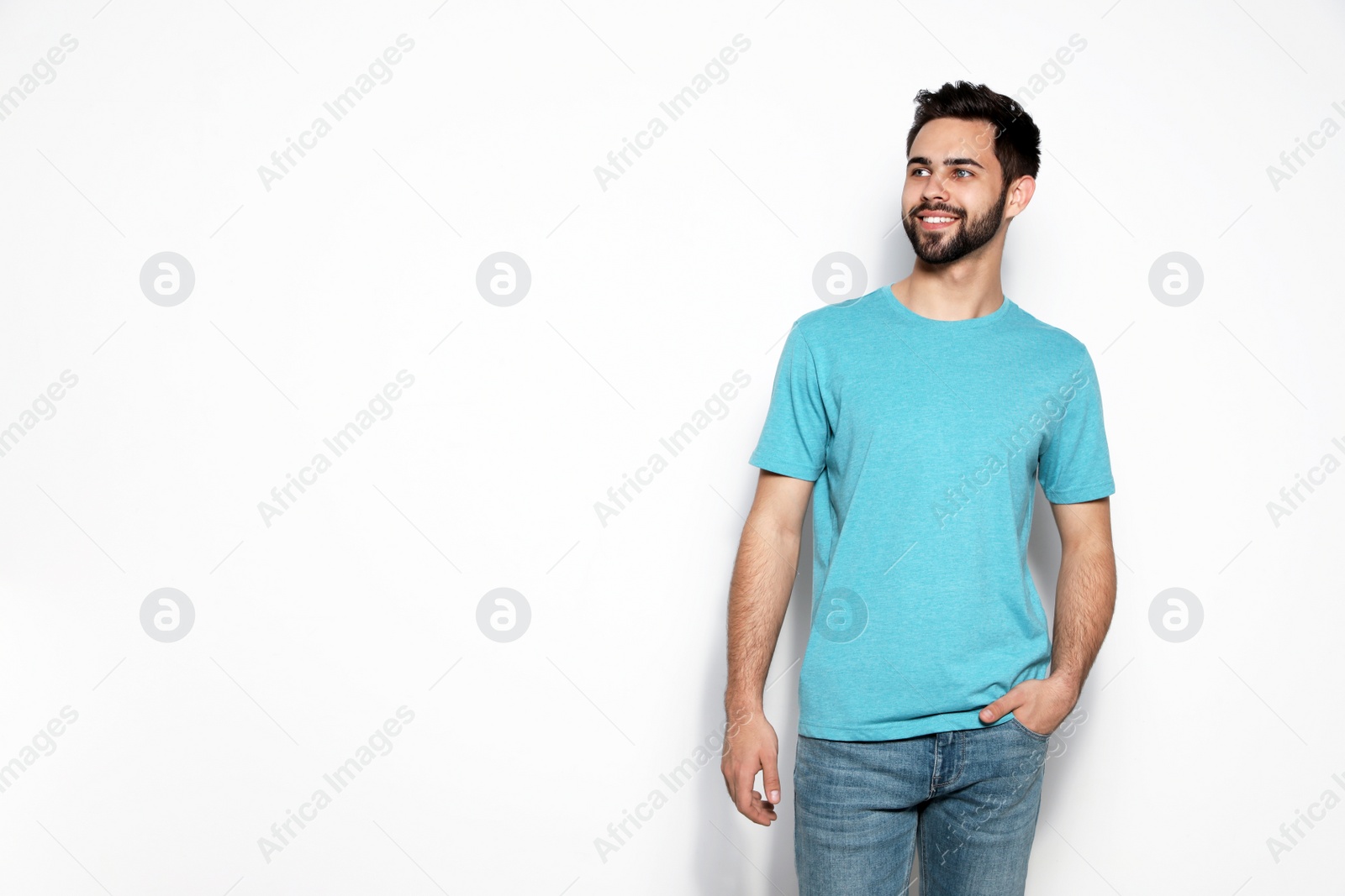 Photo of Young man in t-shirt on light background. Mock up for design