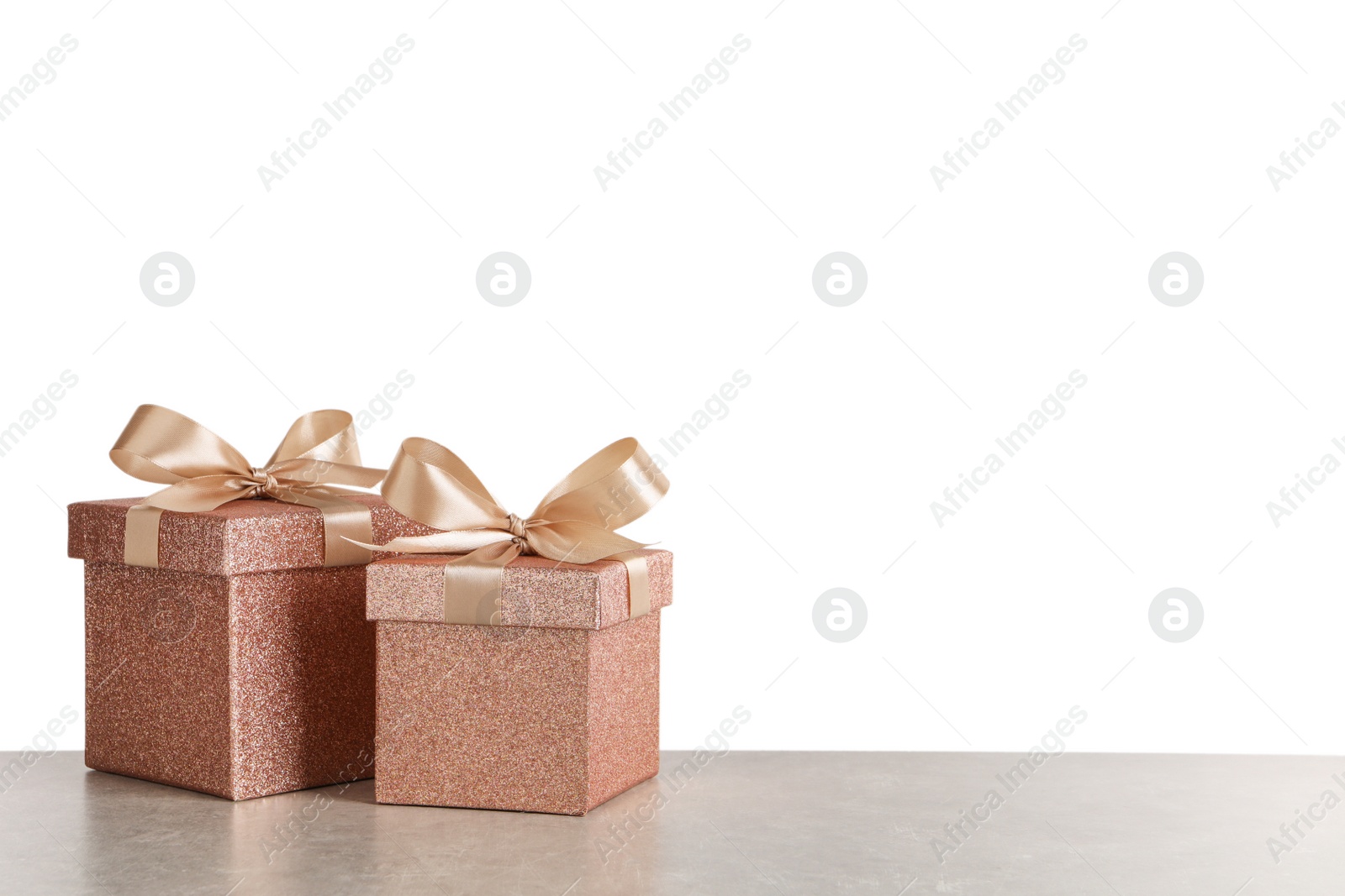 Photo of Two beautiful gift boxes on grey table. Space for text