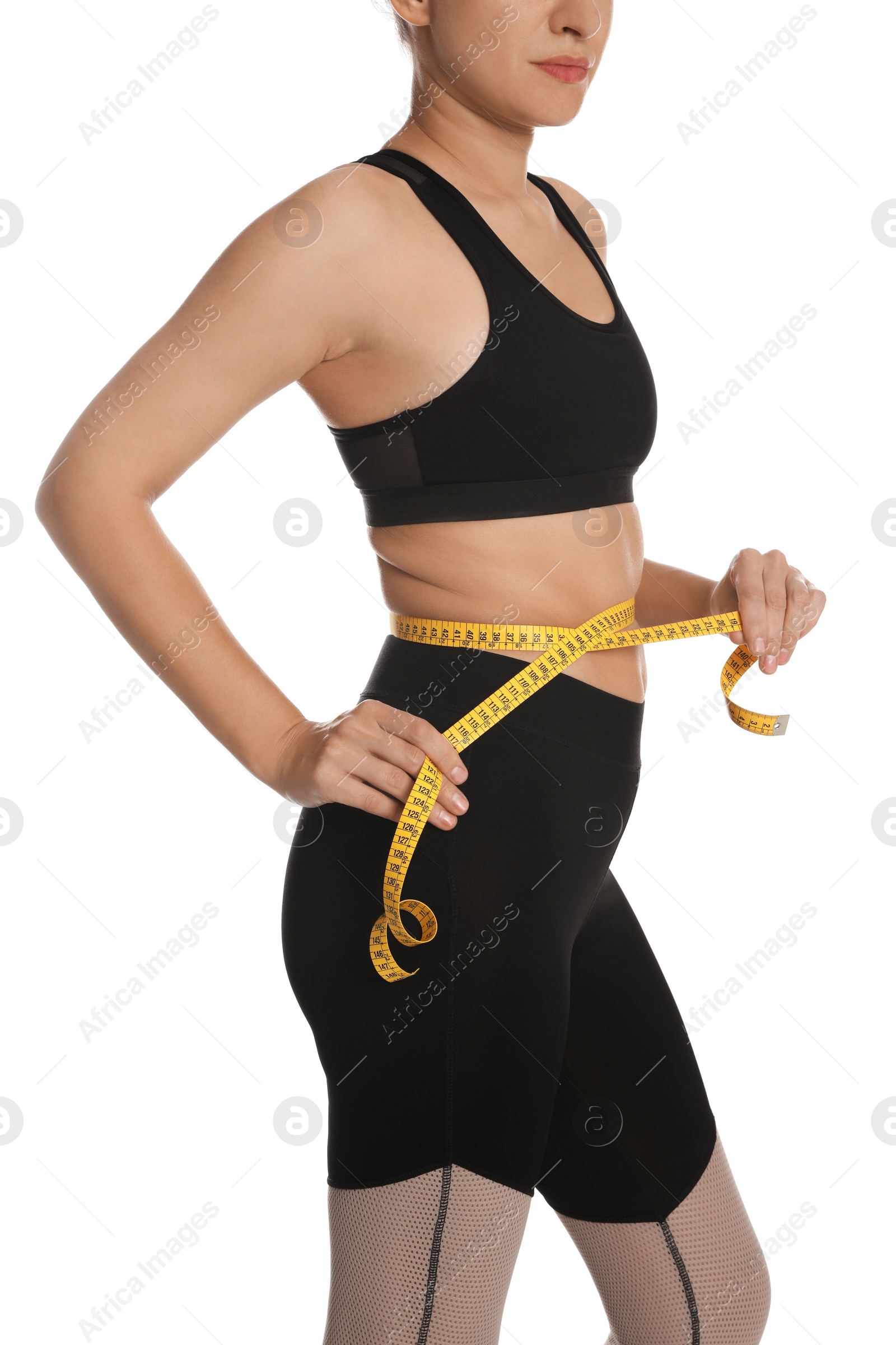 Photo of Woman measuring waist with tape on white background, closeup