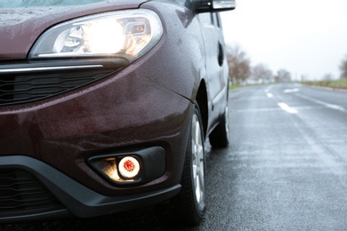 Photo of Car parked outdoors on rainy day, closeup