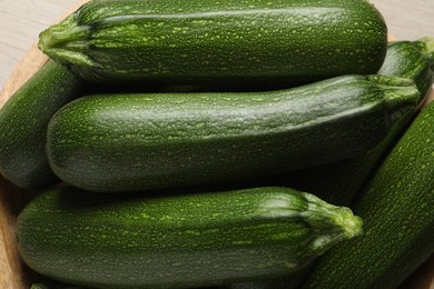 Many raw ripe zucchinis in bowl, closeup