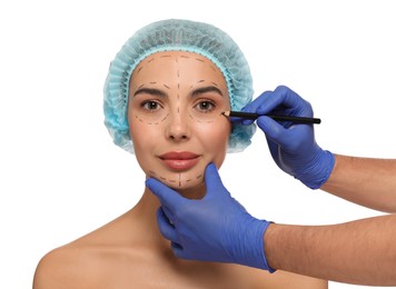 Photo of Doctor with pencil preparing patient for cosmetic surgery operation on white background