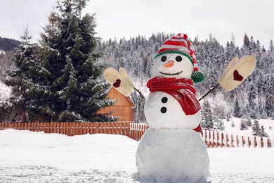 Image of Funny snowman outdoors on sunny day, space for text