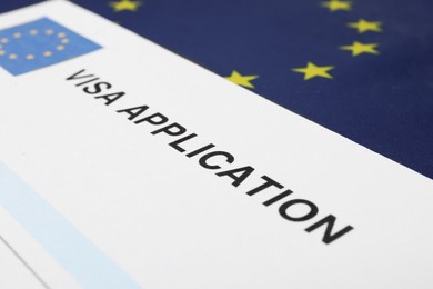 Immigration to Europe. Visa application form on flag, closeup