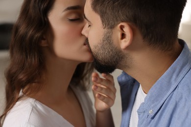 Photo of Love relationship. Passionate young couple kissing indoors, closeup