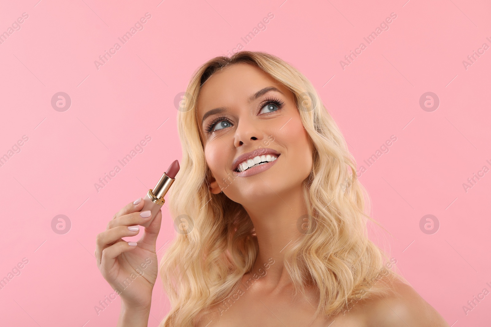 Photo of Beautiful makeup. Smiling woman with lipstick on pink background