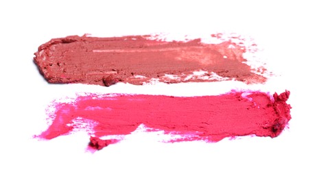 Photo of Smears of beautiful lipsticks on white background