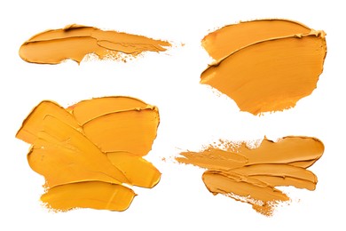 Image of Orange oil paint strokes isolated on white, top view