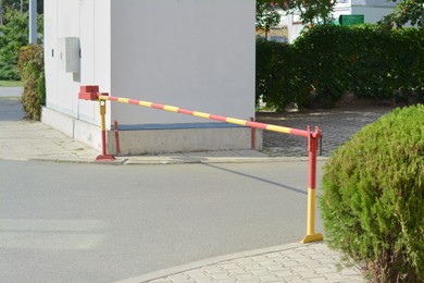 Photo of Closed boom barrier on sunny day outdoors